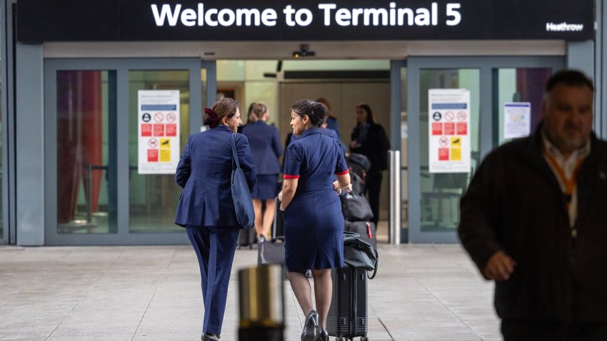 British Airways crew members arrive at terminal 5 at Heathrow on March 21, 2025 in London, England. 